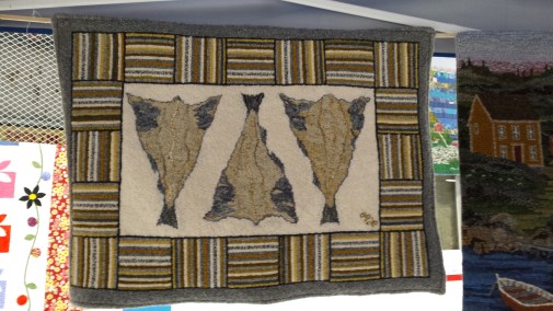 A rug with three dried cod